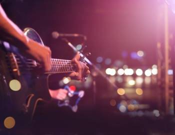 person playing guitar on stage