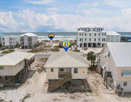 BHive House Beach house with the ocean in front of it