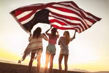 Girls on beach with American Flag