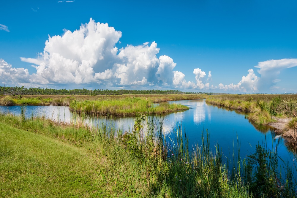Panorama of canals in Gulf Shores State Park in Alabama USA with reflections of sky on water