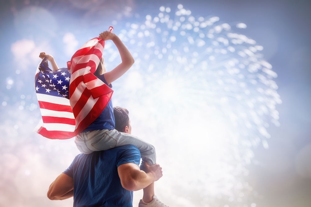 Man and son watching 4th of July fireworks